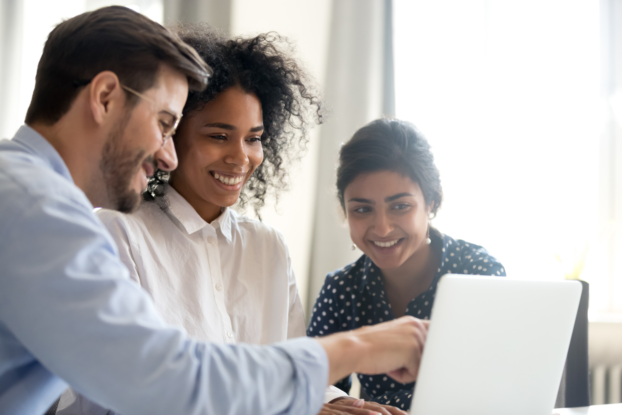 happy people looking at a computer