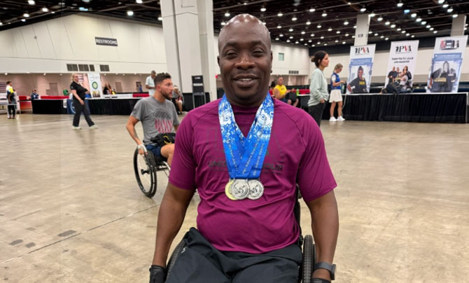 Veteran in wheelchair with medals at convention center