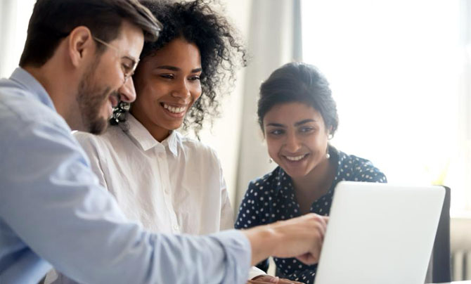 Interns looking at a computer