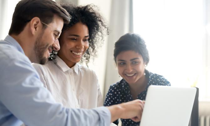 happy people looking at a computer
