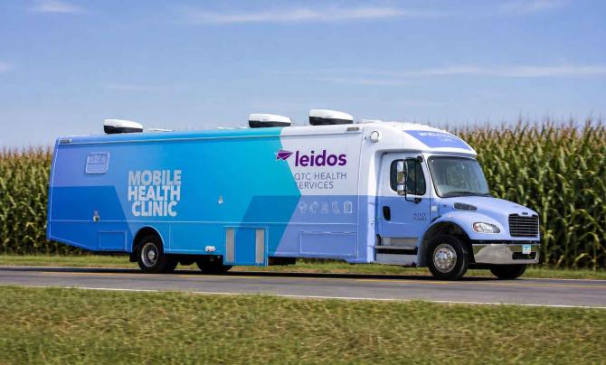 Mobile Health Clinic driving through corn fields 