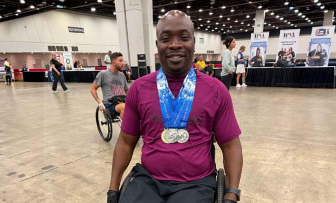 Veteran in wheelchair with medals at convention center