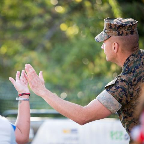 Veteran high-fiving civilian 