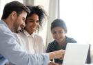 happy people looking at a computer