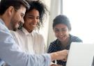 Interns looking at a computer