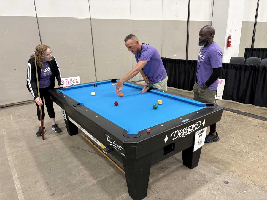 Michelle Juarez (left) enjoying a game of pool of with colleagues.
