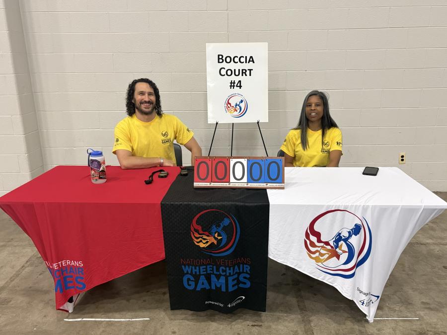 Shika Reynolds (right) and LQTC colleague Harrison Kish (left) at a Boccia check-in table.