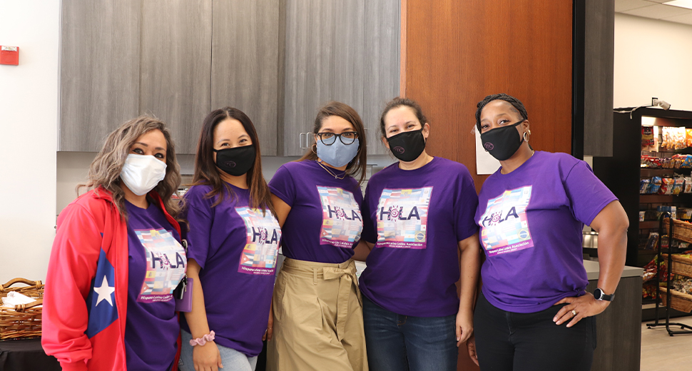 Group of women wearing masks standing together